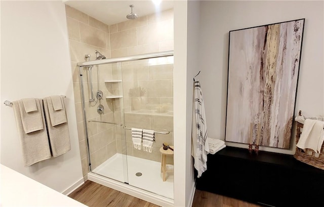 bathroom featuring wood-type flooring and a shower with door