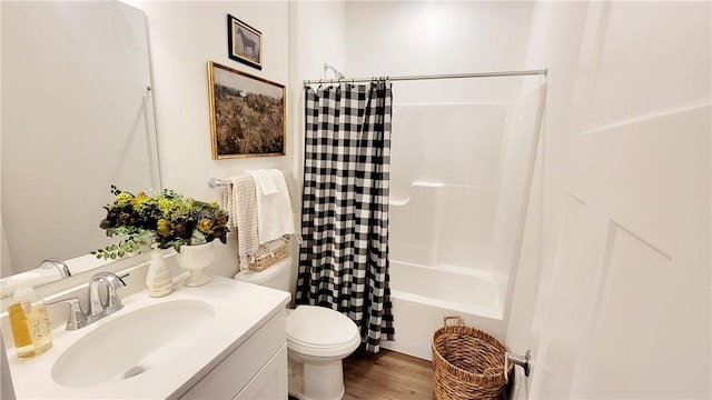 full bathroom with toilet, wood-type flooring, vanity, and shower / tub combo with curtain