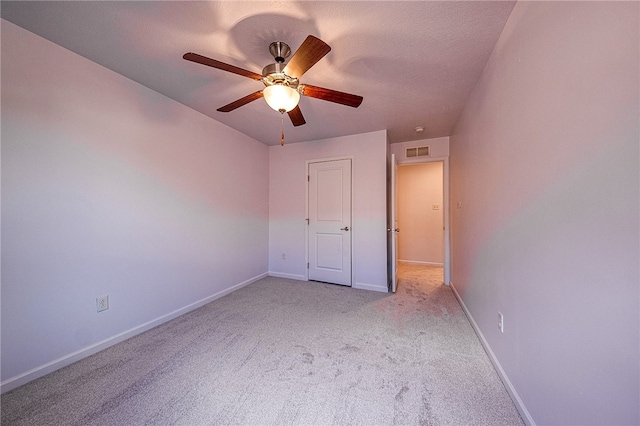 unfurnished bedroom with ceiling fan and light carpet