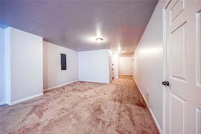 basement with electric panel and light colored carpet