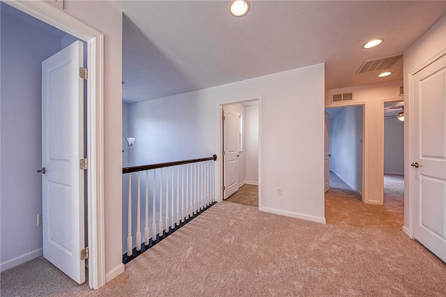 corridor with carpet flooring