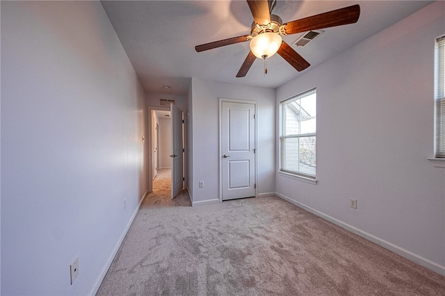 unfurnished bedroom with ceiling fan and light colored carpet