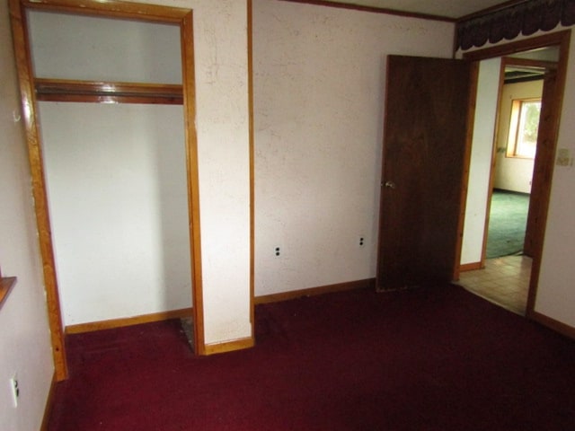 unfurnished bedroom with carpet and a closet