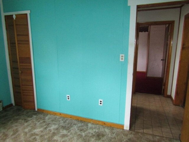 unfurnished bedroom with tile patterned floors and a closet