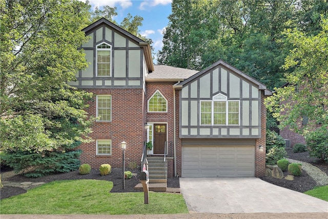 tudor-style house with a front lawn and a garage