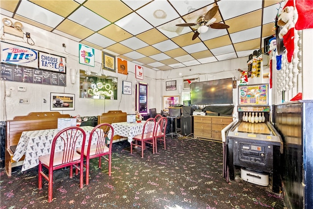 carpeted dining space featuring ceiling fan