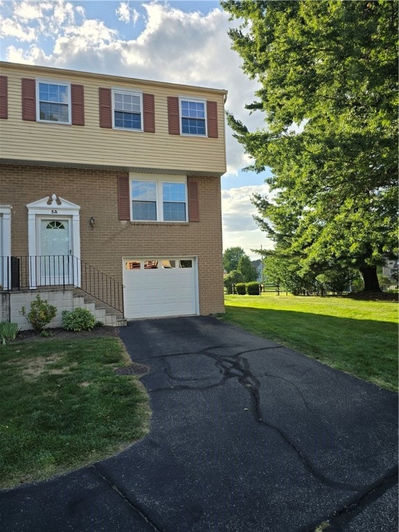 view of front facade with a garage and a front lawn