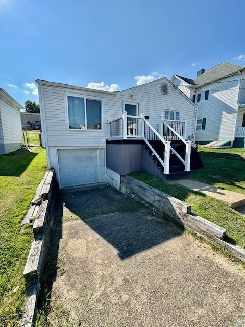 view of front facade featuring a wooden deck, a garage, and a front yard