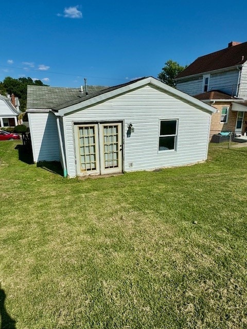 rear view of house featuring a lawn