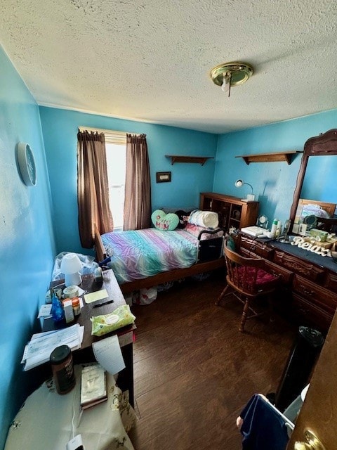 bedroom featuring hardwood / wood-style flooring and a textured ceiling