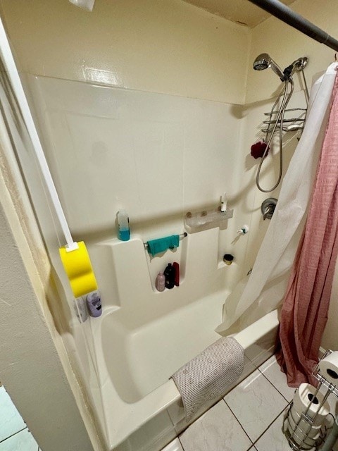 bathroom with tile patterned flooring and shower / tub combo