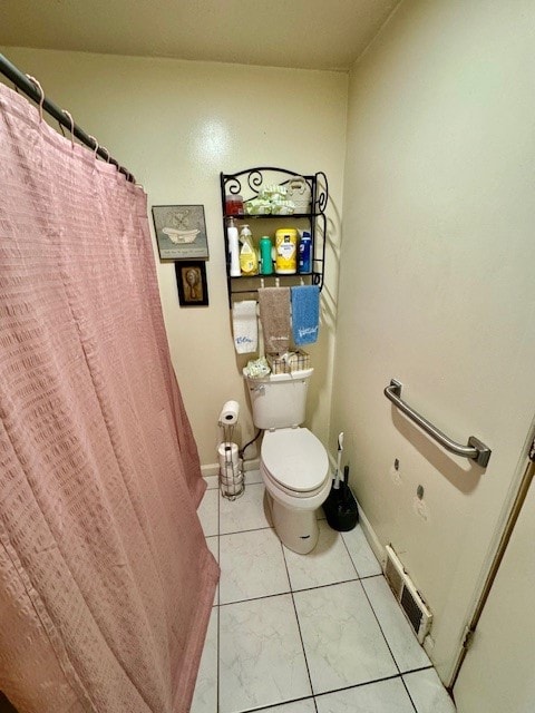 bathroom featuring tile patterned flooring and toilet