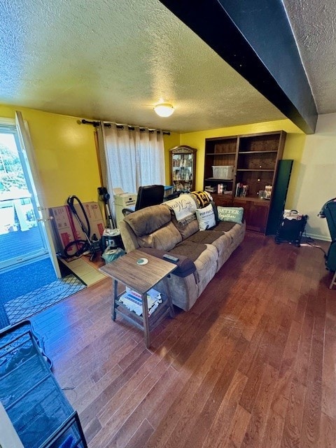 living room featuring a textured ceiling and wood-type flooring