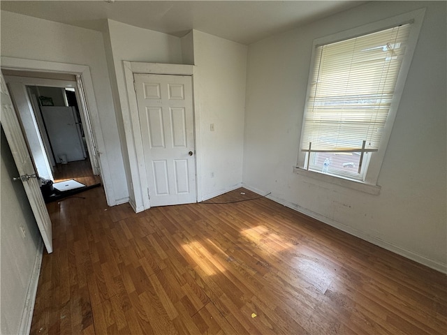 unfurnished bedroom featuring a closet and wood-type flooring