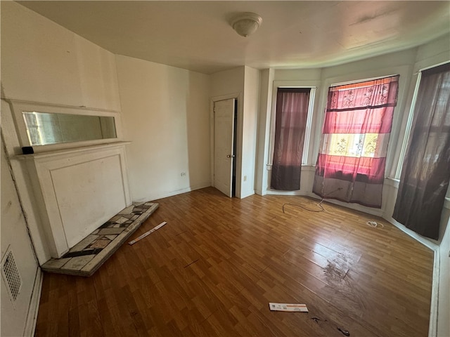 unfurnished living room featuring hardwood / wood-style flooring