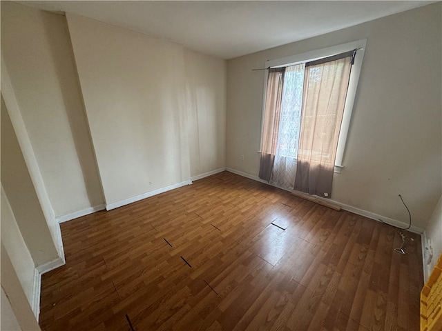 unfurnished room with wood-type flooring