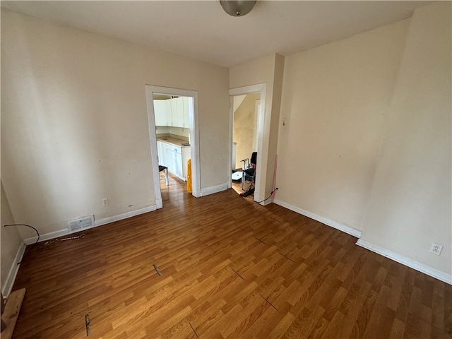 empty room with wood-type flooring