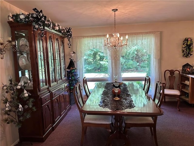 dining room featuring a notable chandelier and carpet floors