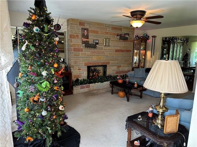 living room with a fireplace, carpet floors, and ceiling fan