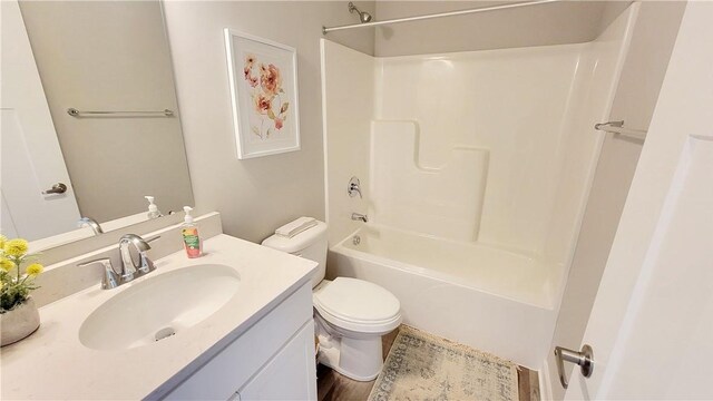 full bathroom featuring toilet, washtub / shower combination, and vanity