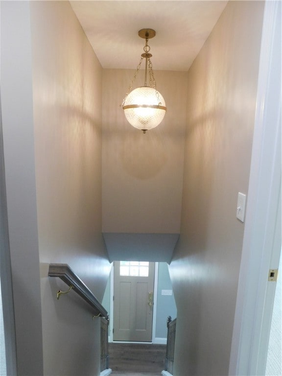 stairs featuring hardwood / wood-style floors