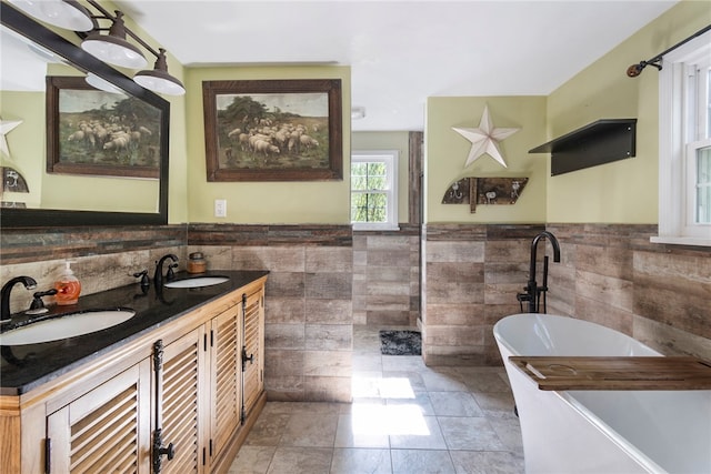 bathroom featuring tile walls, a tub, tile patterned floors, and vanity