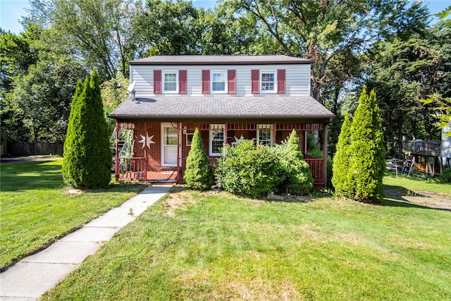 view of front facade with a front yard and covered porch