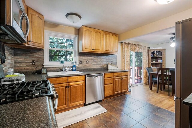 kitchen featuring sink, decorative backsplash, dark wood-type flooring, and stainless steel appliances