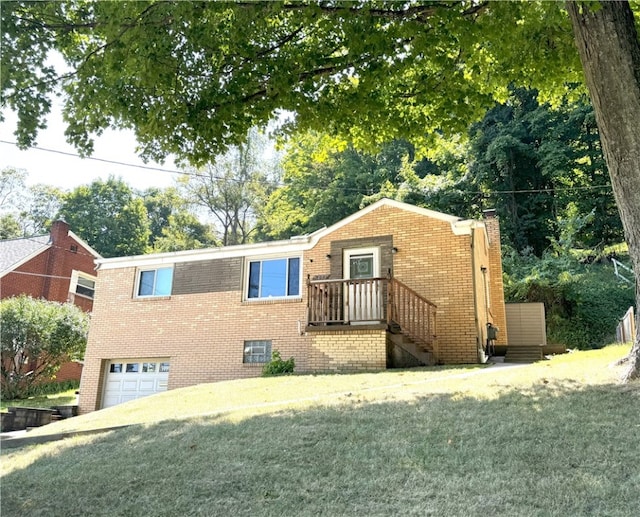 view of front facade with a garage, brick siding, a chimney, and a front yard