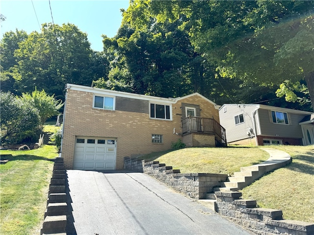 view of front of house with a front yard and a garage