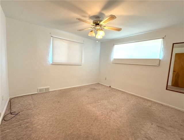 spare room with carpet and ceiling fan