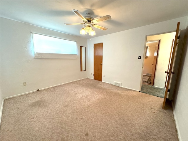 unfurnished bedroom featuring ceiling fan and light carpet