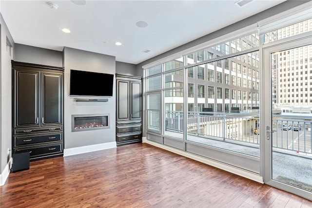 unfurnished living room with dark hardwood / wood-style floors