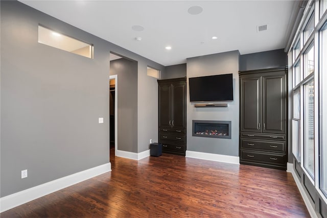 unfurnished living room with dark hardwood / wood-style flooring