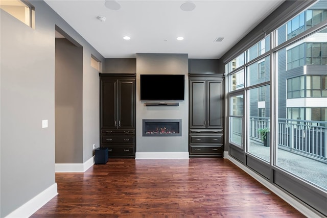 unfurnished living room with dark hardwood / wood-style flooring