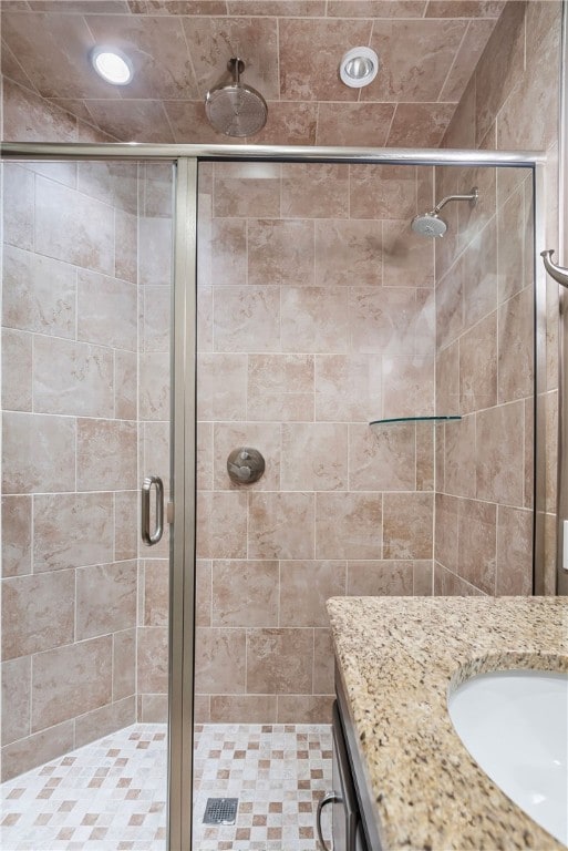 bathroom with vanity and a shower with shower door