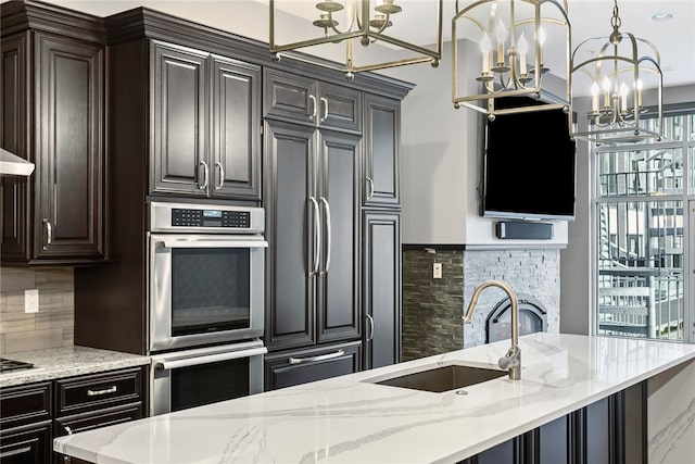 kitchen with decorative backsplash, paneled built in fridge, sink, and double oven