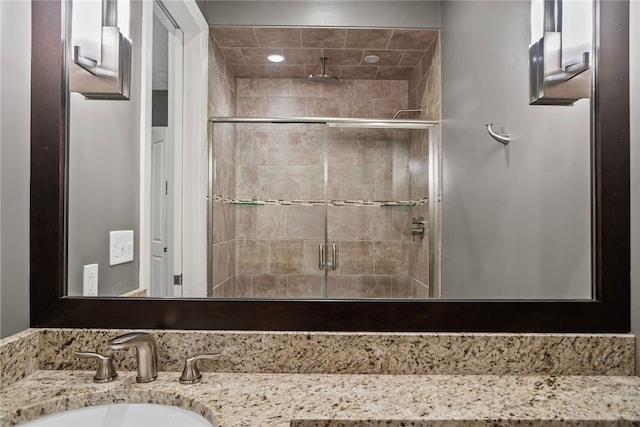 bathroom with vanity and a shower with shower door