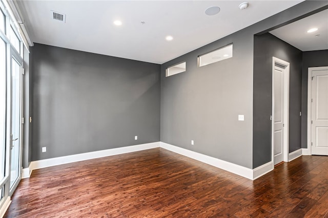 empty room with dark hardwood / wood-style floors