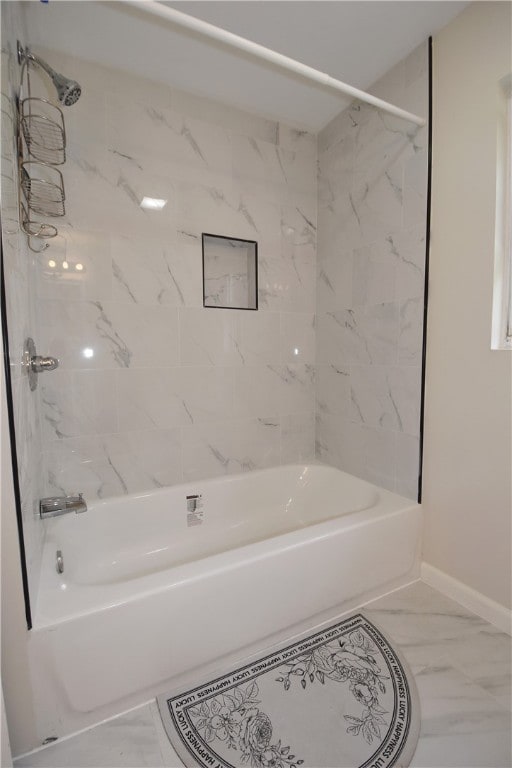 bathroom with tiled shower / bath and tile patterned floors