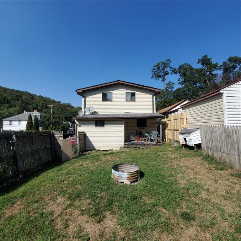 rear view of house with a yard