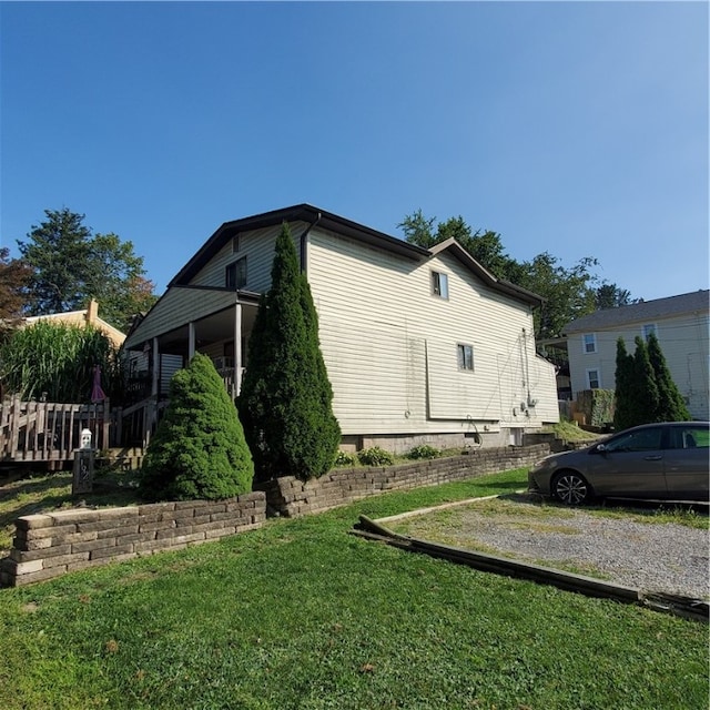 view of side of home with a lawn