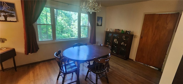 dining room with a wealth of natural light, a notable chandelier, and hardwood / wood-style flooring