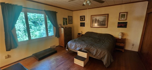 bedroom with ceiling fan, dark hardwood / wood-style floors, and crown molding