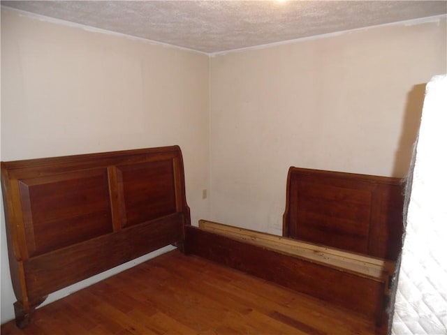 interior space featuring hardwood / wood-style flooring and a textured ceiling