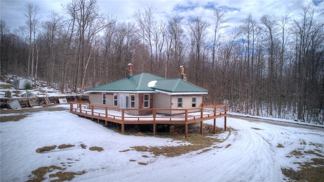 snow covered house with a deck