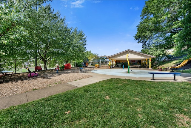 view of property's community with a lawn and a playground