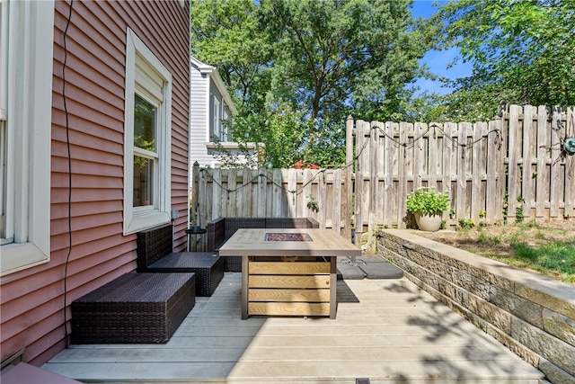 wooden terrace with an outdoor fire pit