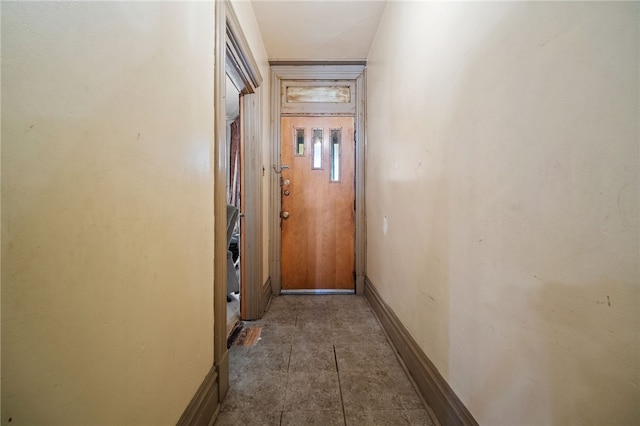 hall with dark tile patterned floors