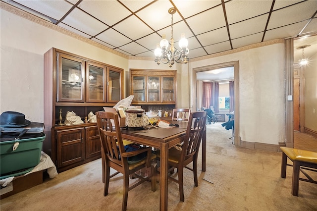 carpeted dining room featuring a notable chandelier